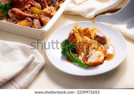 Roast Chicken served with Veg and Gravy being poured Royalty-Free Stock Photo #2239972653