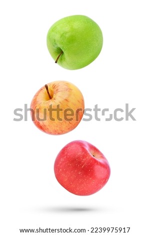 Whole apple falling in the air isolated on white background.