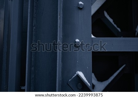 Metal ladder. A close-up photo of a technological metal black structure. Abstract background image on the theme of modern architecture. mounting, bolt