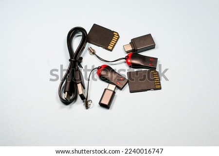 USB cable and flash drives on a blue isolated background