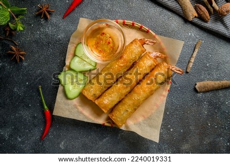 Spring rolls fried with shrimps on dark table top view Royalty-Free Stock Photo #2240019331