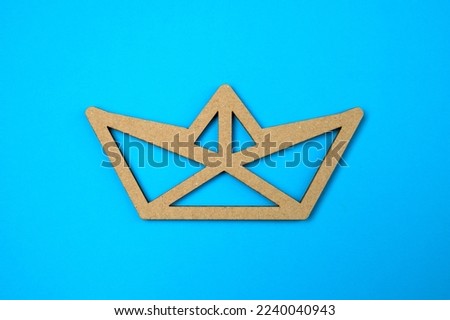 Paper cut boat on blue background. The concept of success and safety. Good conditions. Reliable business.