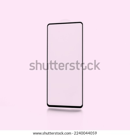protective glass for a smartphone on a pink background