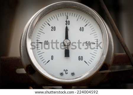 Round  infustrial thermometer on chemical plant