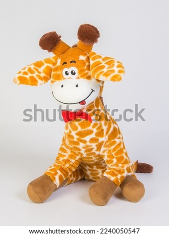 Plush spotted giraffe. Soft children's toy on a white background.