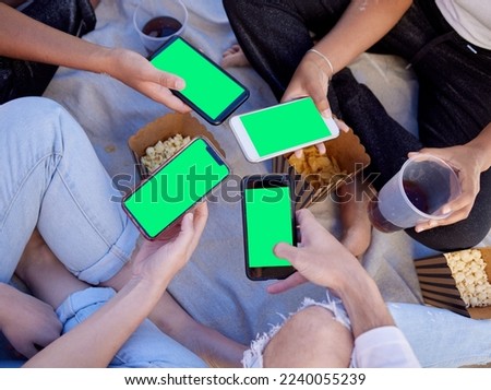 Top view, hands or friends with green screen phone for social media app, internet esports game or 5g network software. Men, women or people with mock up technology space, smartphone or beach picnic