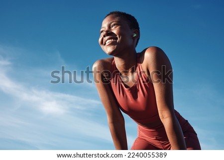 Fitness, black woman and happy athlete smile after running, exercise and marathon training workout. Blue sky, summer sports and run of a African runner breathing with happiness from sport outdoor Royalty-Free Stock Photo #2240055389
