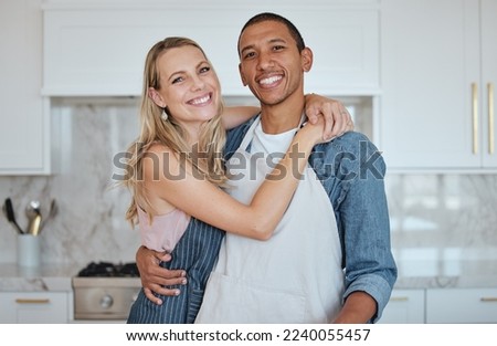 Kitchen, couple and hug portrait with love, care and smile at home ready for meal cooking. Interracial happy couple loving marriage, diversity and diet nutrition in a house hungry for food together