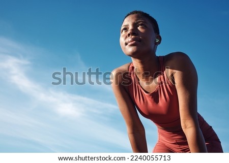 Black woman, exercise or tired after training, running or workout for balance, wellness or health outdoor. Sky, African American female, runner or athlete relax, breathing or focus for cardio or rest Royalty-Free Stock Photo #2240055713