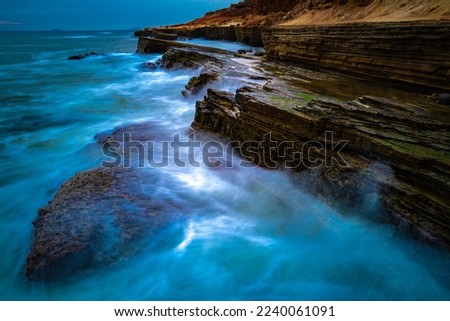 San Diego Seascape Series, turquoise-colored seawater and white silky seafoam splashing to the cliff at Sunset Cliffs in Cabrillo National Monument, Southern California, USA, long exposure photography