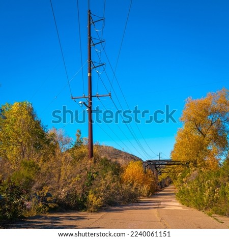 Power poles and lines, or electricity pylons and cables over the Sweetwater River Bridge in San Diego National Wildlife Refuge in Jamul, Southern California