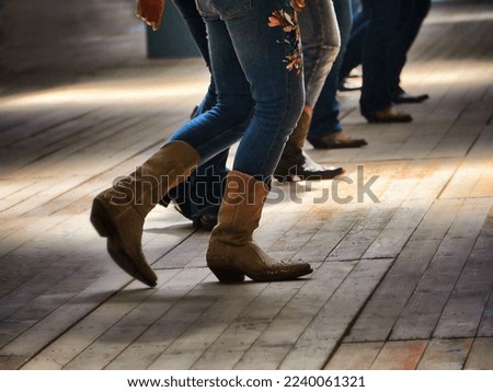 A closeup shot of the legs of traditional western folk dancing under the music