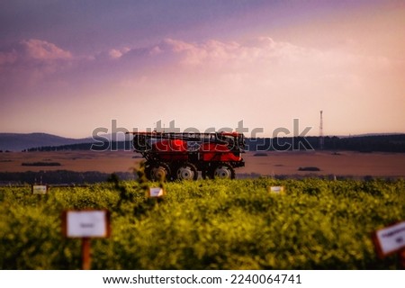 an industrial self-propelled sprayer spreader in the field at sunset Royalty-Free Stock Photo #2240064741