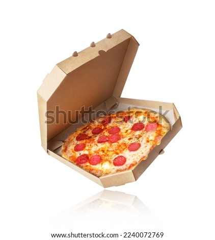 Freshly baked pizza with sausage in a cardboard box on a white background