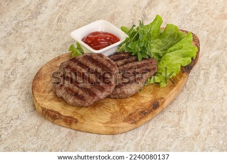 Grilled beef burger cutlet with tomato sauce