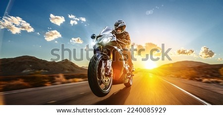 motorbike on the road riding. having fun driving the empty road on a motorcycle tour journey. copyspace for your individual text. Royalty-Free Stock Photo #2240085929