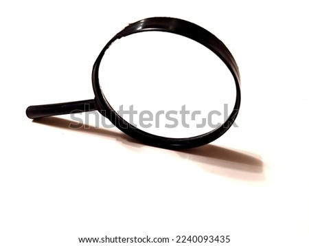 magnifier. one magnifier with black handle on white background. closeup photo