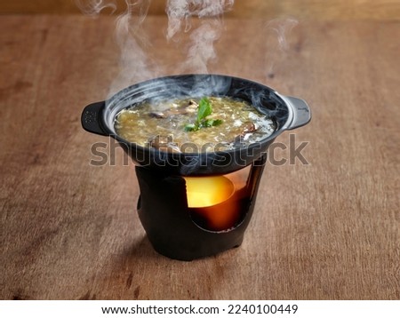 Shark Fin Soup served in stew dish isolated on table side view of soup Royalty-Free Stock Photo #2240100449