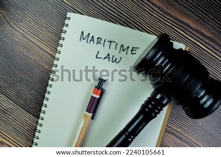 Concept of Maritime Law write on a book gavel isolated on Wooden Table.