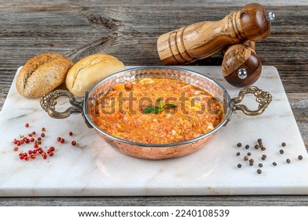 Traditional turkish food menemen made by eggs, tomatoes and green pepper. Royalty-Free Stock Photo #2240108539