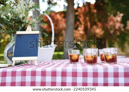 Summer background with tintos de verano on a checkered tablecloth in a typically Spanish open-air cocktail