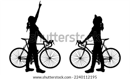 Two girls with bicycles. The girl holds the steering wheel of a bicycle with her hand, with the other hand she shows the direction up. The other girl is staring at the direction of the hand up.