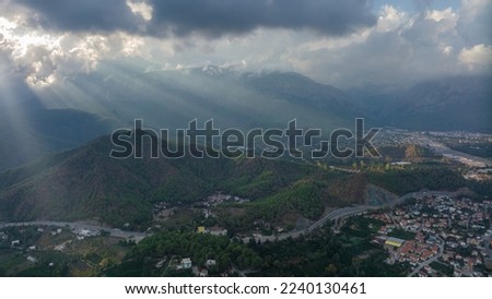 Sunbeams through the clouds. Aerial drone view of resort town. Mountain landscape. Photography. High quality photo