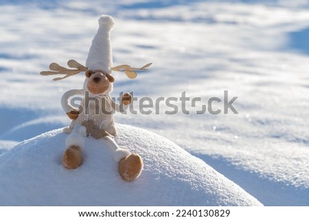 Figure of chrismas deer on snowy field. Concept of funny winter day and christmas spirit.