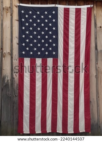 American flag hanging on a barn