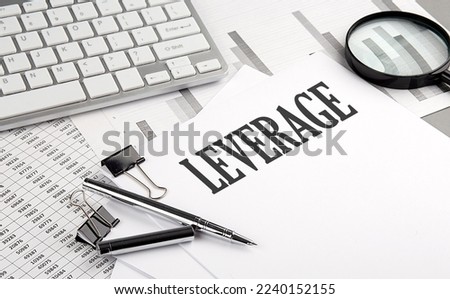 LEVERAGE text on a paper with chart and keyboard, business concept Royalty-Free Stock Photo #2240152155