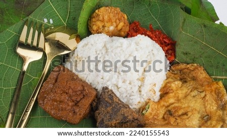 Nasi Jamblang or Nasi Campur typical of Cirebon, Indonesia. White rice with a mixture of various side dishes covered with teak leaves. Selective Focus