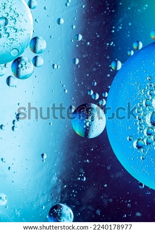 Abstract gradient blurred background in blue tones. Geometric shapes balls of different sizes. fantastic picture of space. Vertical macro photo, selective focus 