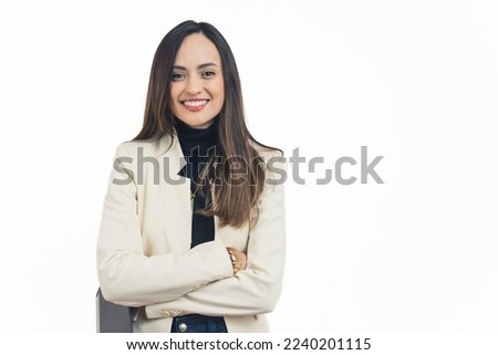 Fashionable latin american businesswoman standing with arms crossed smiling at camera. Business owner. Female manager. White background copy space horizontal studio shot. High quality photo