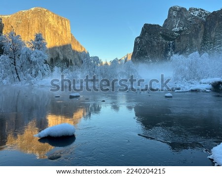 Winter in Yosemite Valley. Snow trees and rocky background. Blue background. Yosemite National Park. El Captain and Bridal veil Fall