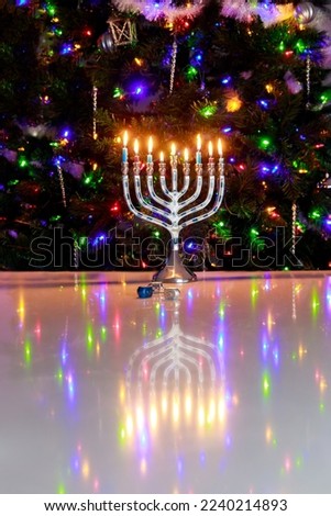 Hanukkah celebrates with a menorah burning with nine candles.