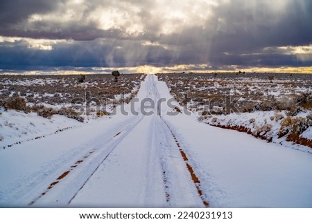 Beautiful snowy dirt road leading to Muley Point near Mexican Hat, Utah Royalty-Free Stock Photo #2240231913