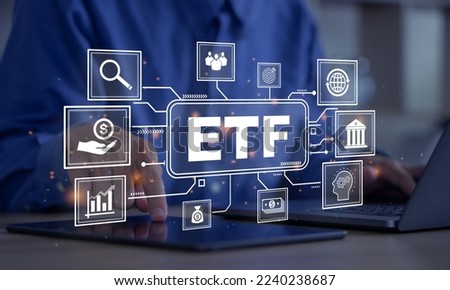 ETF,Exchange traded fund.Businessmen using a laptop and tablet with icons of ETF.Business finance concept.Stock market index fund.
