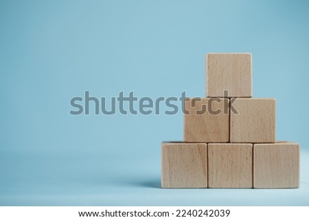 Business design,financial,education,abstract,logo,text concept.,Five Blank Wooden cubes stack in pyramid shaped on right side over blue background with copyspace.,Banner,wallpaper,background idea.