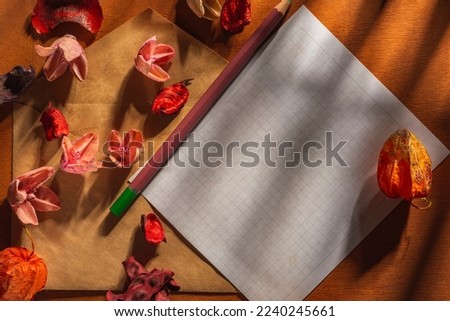 An envelope for a letter lies on a wooden table of a dark background