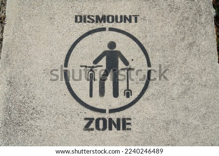 Dismount zone painted sign over the bridge at Miami, Florida. Dismount zone signage painted over the concrete pathway of the bridge.