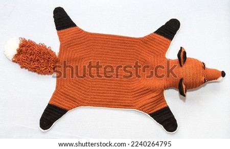Cuddly crocheted fox - childrens toys and bedside rug, bird's eye view