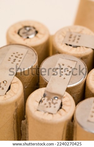 Environment Ideas. Extreme Closeup of Bundle of Soldered Ni-Mh Rechargeable Batteries  Placed Together Over Beige.Vertical image Royalty-Free Stock Photo #2240270425