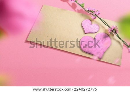 Empty brown paper and flower stem with heart and a colored background. Valentines Day. Empty space for copy space