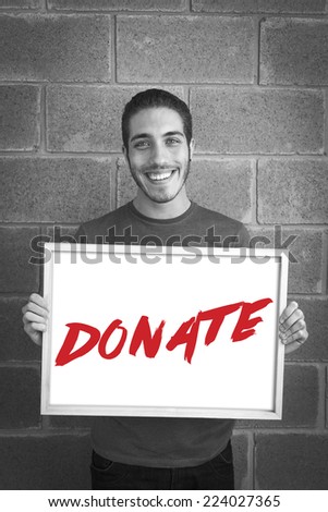 happy young man showing and displaying board with text: Donate Campaign
