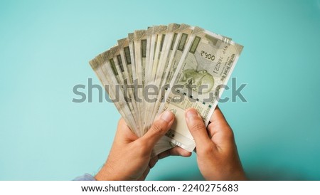 Unrecognizable hand counting five hundred Indian rupees, Close up of hand holding cash. Royalty-Free Stock Photo #2240275683
