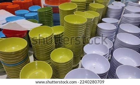 stacks of melamine plates of various colors Royalty-Free Stock Photo #2240280709