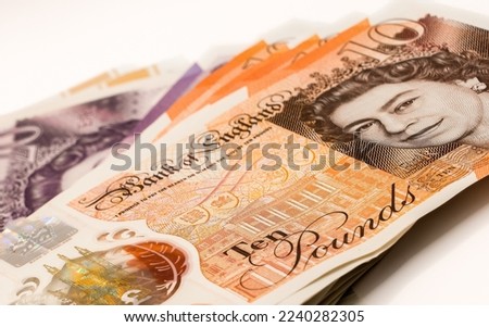 a few hundred pound of new GBP £ Sterling Twenty 20 and Ten 10 pound notes in a small fanned stack Royalty-Free Stock Photo #2240282305