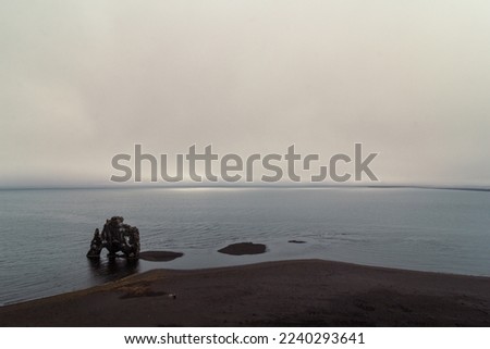 Hvitserkur rock on sea beach landscape photo. Beautiful nature scenery photography with heavy fog on background. Idyllic scene. High quality picture for wallpaper, travel blog, magazine, article