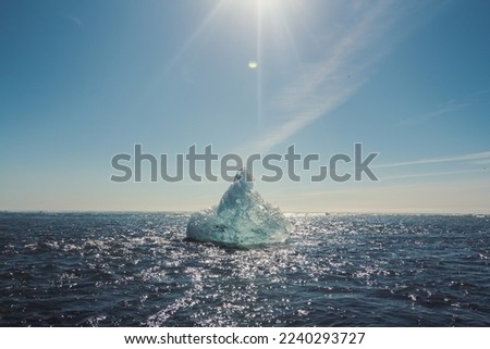 Large glacier in azure sea landscape photo. Beautiful nature scenery photography with blue sky on background. Idyllic scene. High quality picture for wallpaper, travel blog, magazine, article