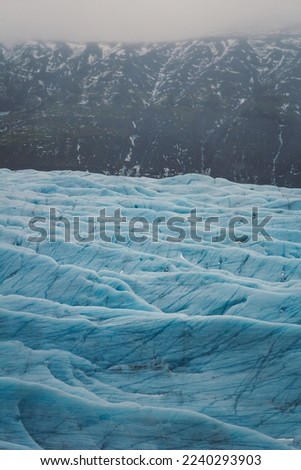 Ice field in ridge bottom landscape photo. Beautiful nature scenery photography with mountain on background. Idyllic scene. High quality picture for wallpaper, travel blog, magazine, article